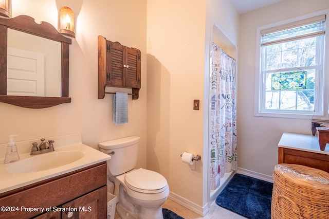 bathroom featuring a shower with curtain, toilet, tile patterned flooring, baseboards, and vanity