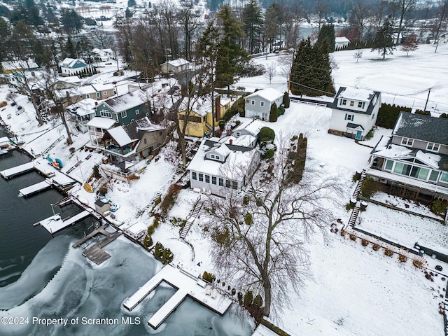 snowy aerial view featuring a residential view