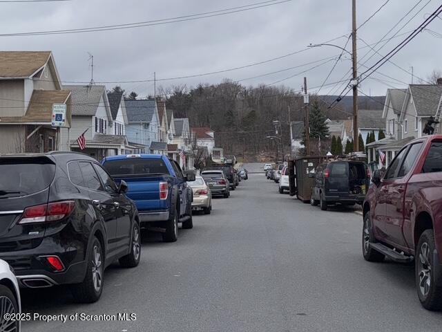 view of road with a residential view and street lighting