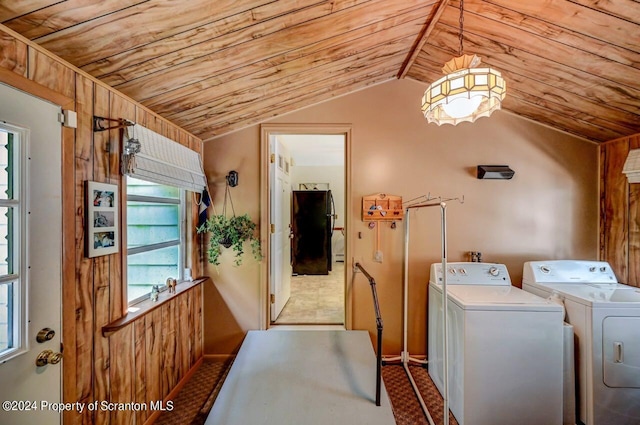 laundry room with washing machine and clothes dryer and wood ceiling