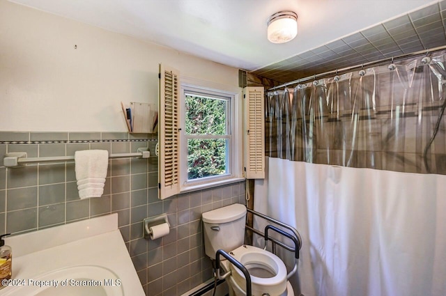 bathroom with a shower with curtain, toilet, and tile walls