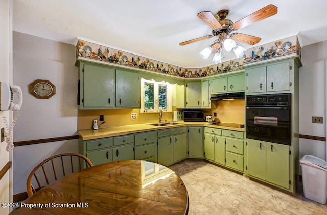 kitchen with black appliances, ceiling fan, sink, and green cabinetry