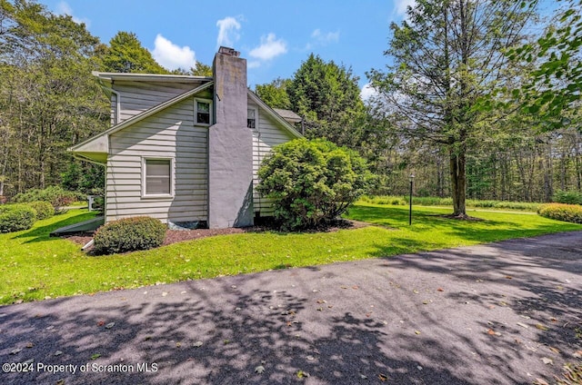 view of property exterior featuring a lawn