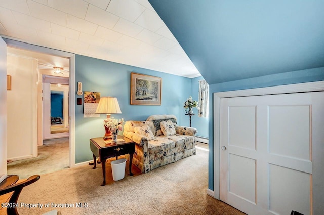 carpeted living room with a baseboard heating unit