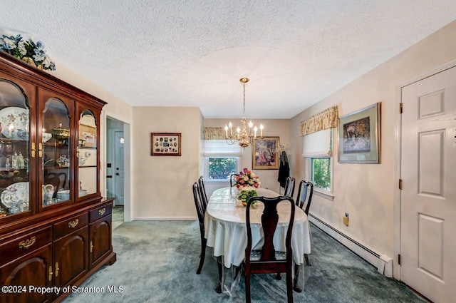 carpeted dining space featuring plenty of natural light, a textured ceiling, a chandelier, and a baseboard heating unit