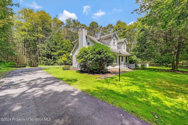 view of side of home featuring a lawn