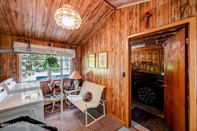 sitting room featuring separate washer and dryer, wooden walls, wood ceiling, and vaulted ceiling