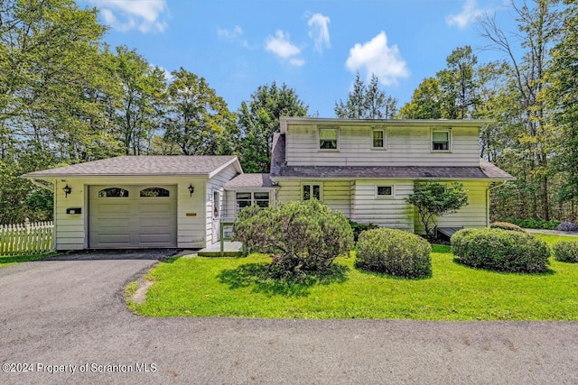 view of front of property with a garage and a front yard