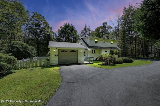 view of front of property featuring a garage and a yard