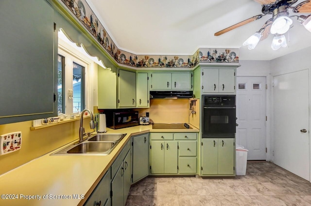 kitchen with black appliances, ceiling fan, green cabinets, and sink