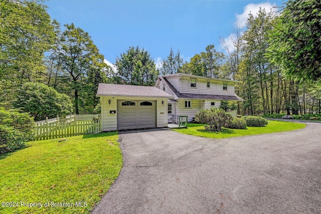 view of front of property with a garage and a front yard