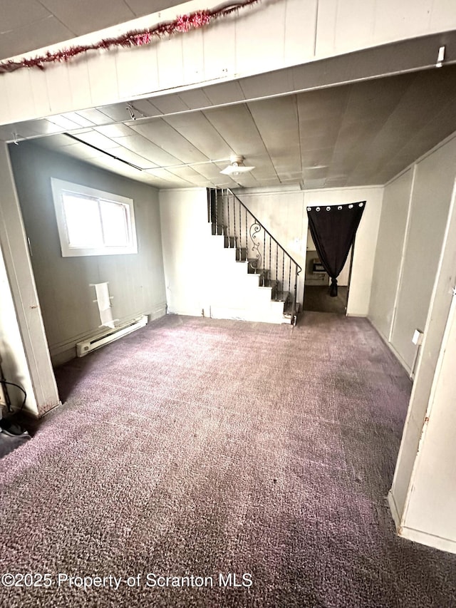 basement featuring carpet floors and a baseboard radiator