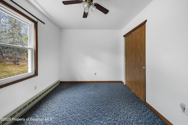 carpeted spare room featuring a ceiling fan, baseboards, and baseboard heating