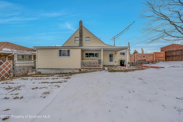 snow covered property featuring a porch