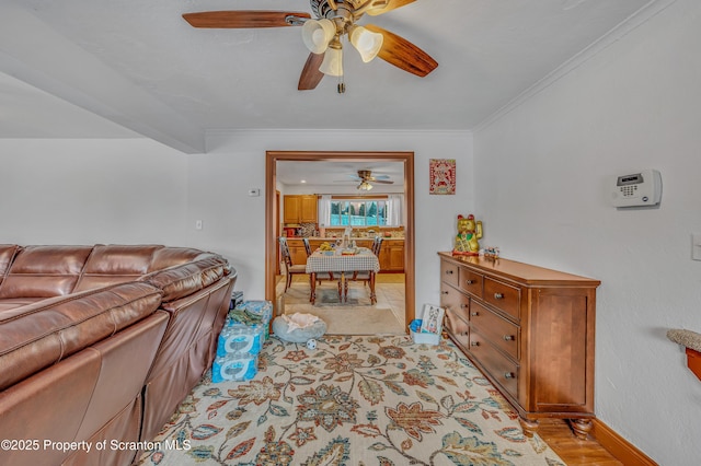 living room with ornamental molding and ceiling fan