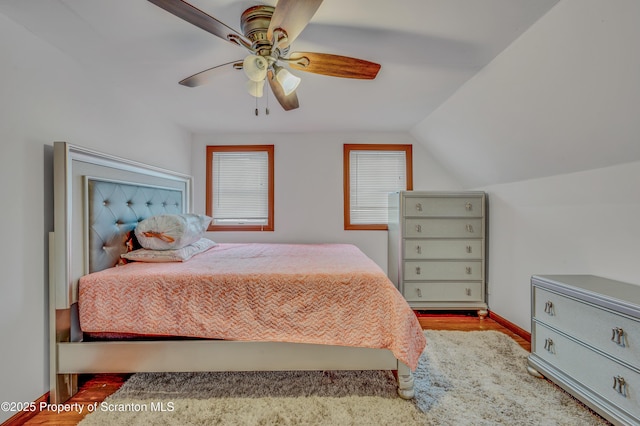 bedroom featuring lofted ceiling, ceiling fan, and light hardwood / wood-style floors