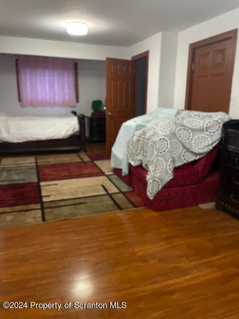 bedroom with hardwood / wood-style floors