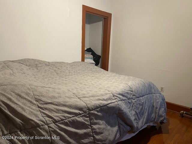 bedroom featuring dark wood-type flooring