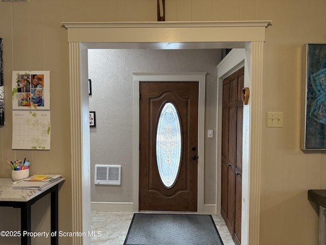 entryway with a textured wall and visible vents