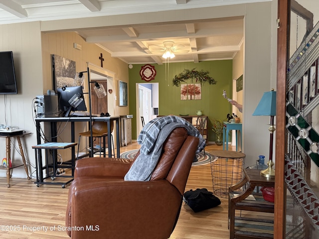 living room featuring a ceiling fan, beamed ceiling, and wood finished floors