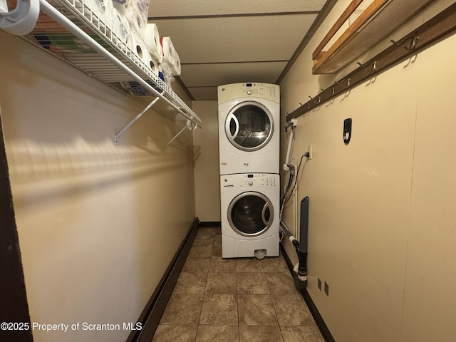 146 S Hyde Ave, Scranton, PA 18504 - washroom with estacked washer and dryer and dark tile patterned flooring