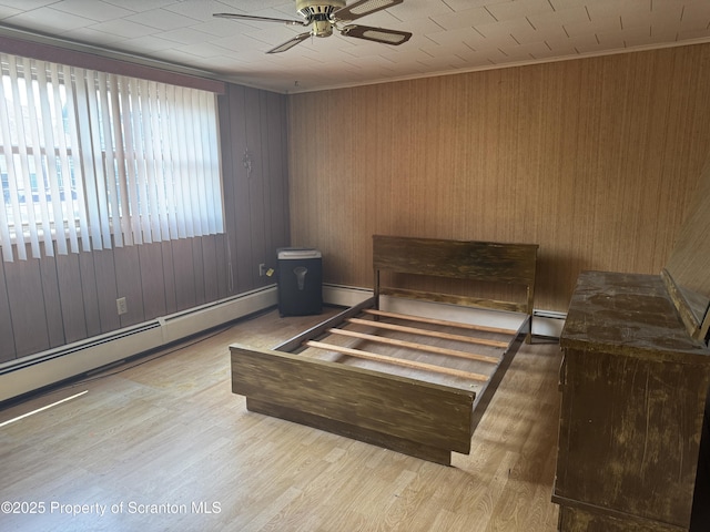 146 S Hyde Ave, Scranton, PA 18504 - bedroom featuring wood finished floors, a baseboard radiator, ornamental molding, wood walls, and ceiling fan