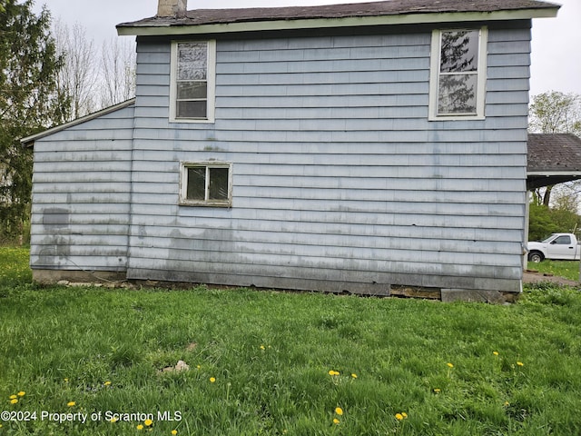 view of home's exterior featuring a yard