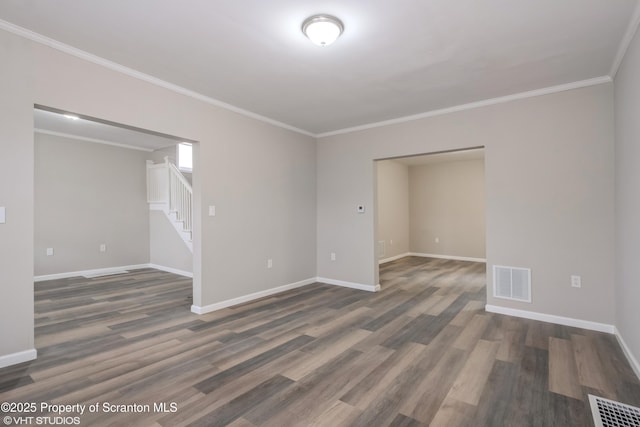 empty room with crown molding and dark hardwood / wood-style floors