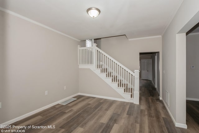 stairway with hardwood / wood-style flooring and crown molding