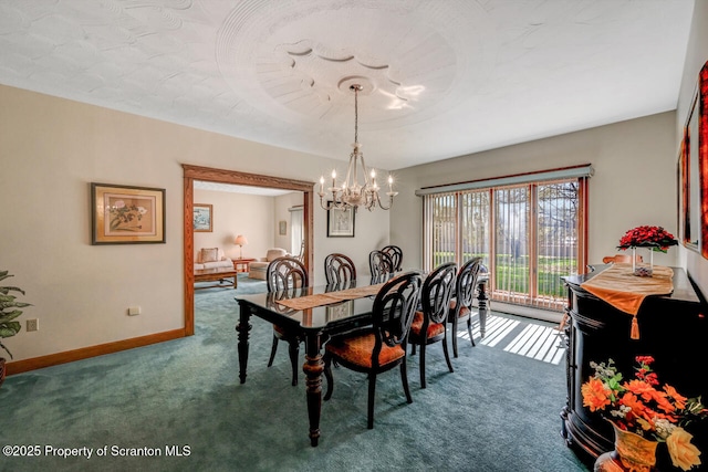carpeted dining room with an inviting chandelier and baseboards