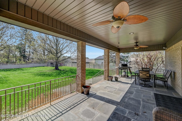 view of patio / terrace featuring a fenced backyard, a ceiling fan, and outdoor dining space