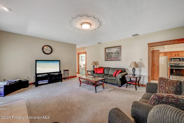 living area featuring baseboards, light colored carpet, and visible vents