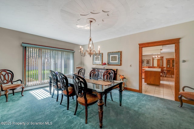 dining room featuring an inviting chandelier, baseboards, light tile patterned floors, and light colored carpet