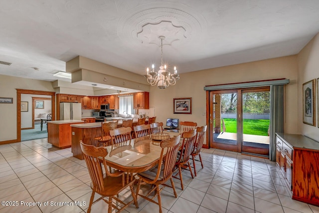 dining area with baseboards, light tile patterned floors, a chandelier, and a healthy amount of sunlight
