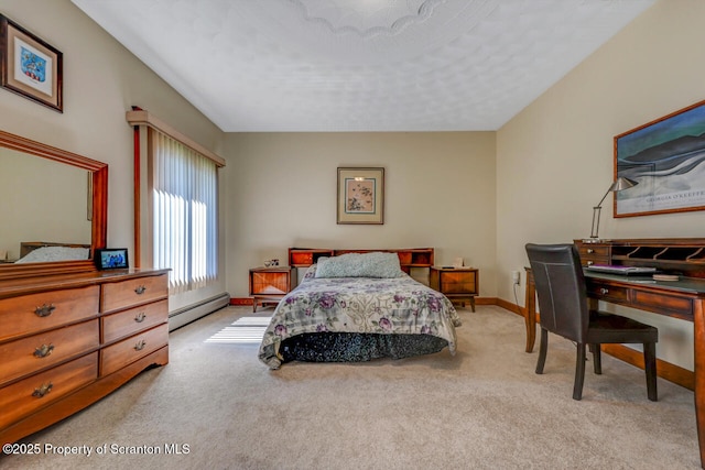 carpeted bedroom featuring baseboards and a baseboard heating unit