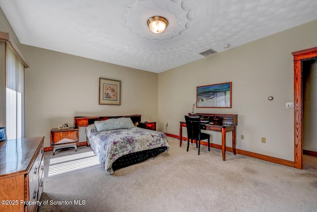 carpeted bedroom with baseboards and visible vents