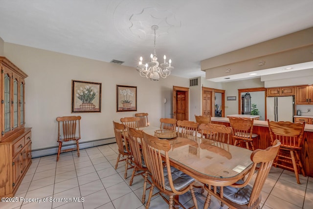 dining area with visible vents, baseboard heating, light tile patterned flooring, and a chandelier