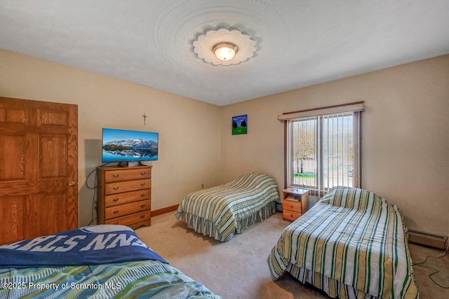 bedroom with a baseboard radiator and carpet