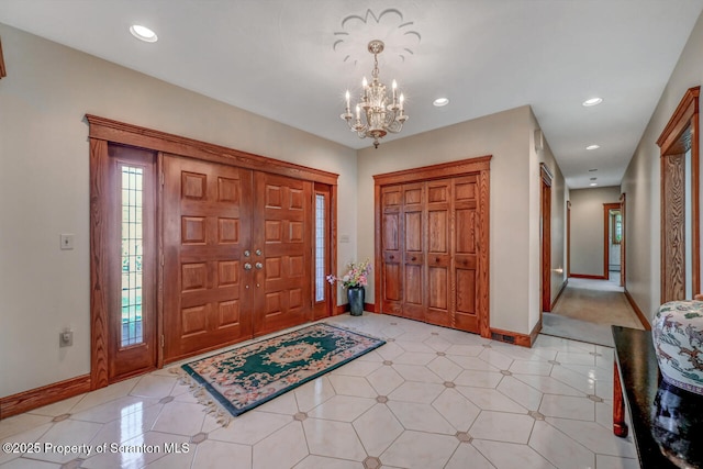foyer entrance with recessed lighting, baseboards, and a chandelier