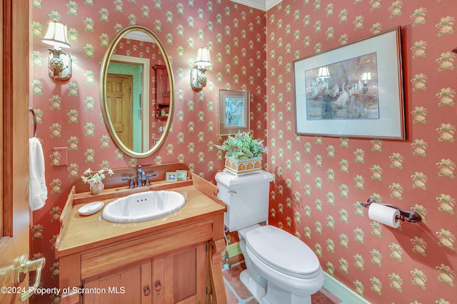 bathroom featuring vanity, toilet, and ornamental molding