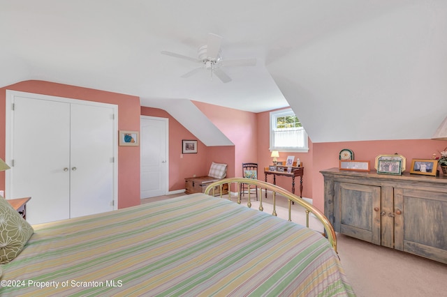 carpeted bedroom featuring ceiling fan, a closet, and vaulted ceiling