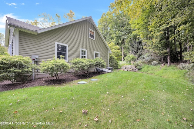 view of side of home featuring a yard