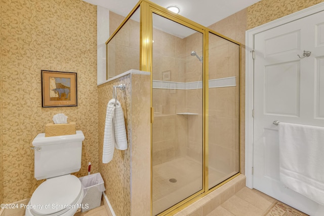 bathroom featuring tile patterned floors, toilet, and walk in shower