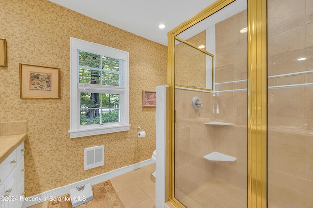 bathroom with tile patterned flooring, toilet, vanity, and walk in shower