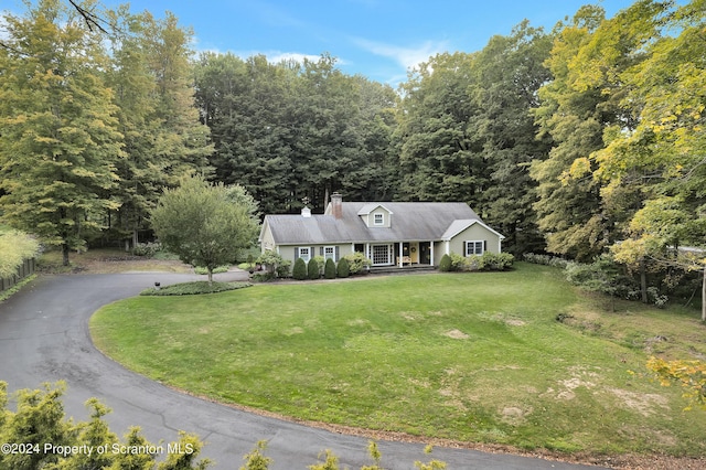 cape cod-style house featuring a front lawn and covered porch