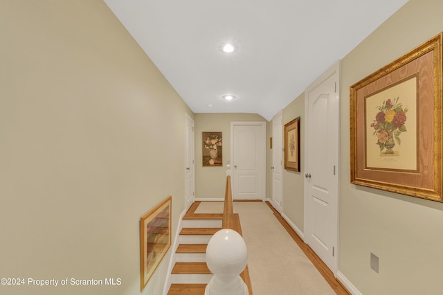 hall featuring lofted ceiling