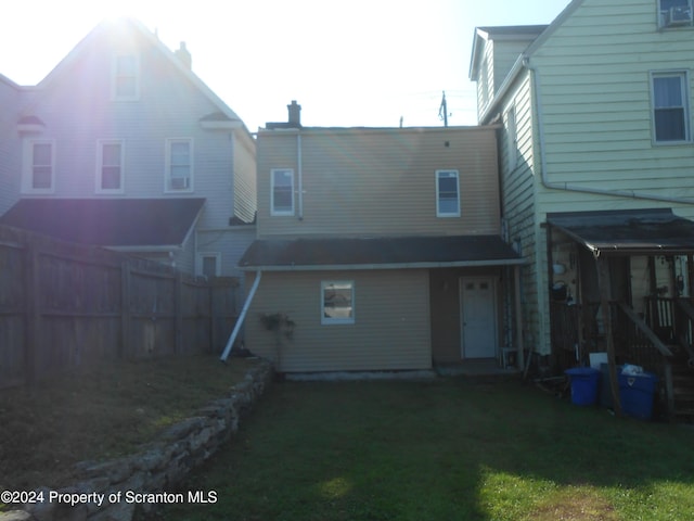 rear view of property with a yard