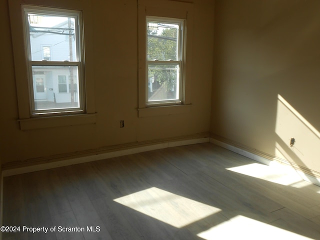 spare room with hardwood / wood-style floors