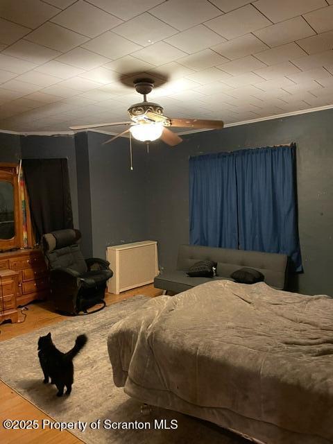 bedroom featuring ceiling fan and wood finished floors