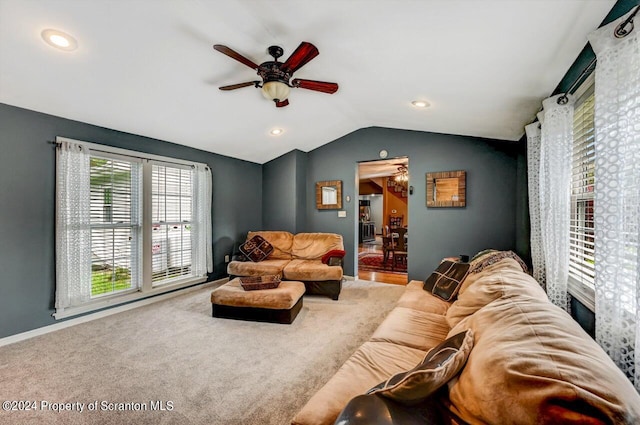 living room featuring carpet flooring, ceiling fan, and lofted ceiling